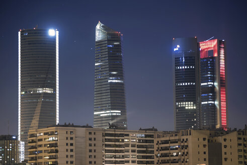 Spain, Madrid, lighted skyscrapers at financial district by night - DHCF00102