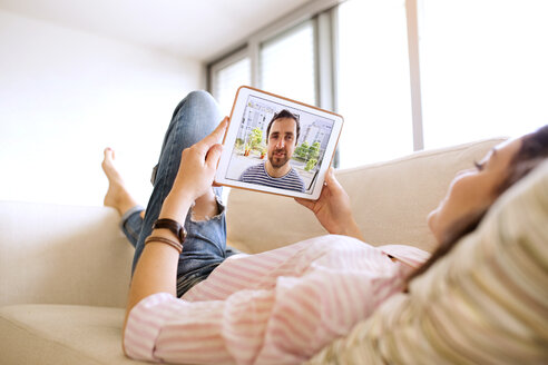 Young woman using tablet for video chat at home - HAPF01891