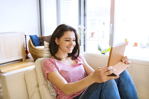 Young woman using tablet for video chat at home stock photo