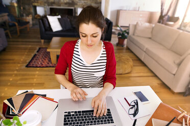 Woman working at desk at home - HAPF01899