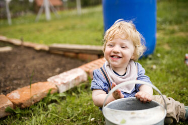 Junge im Garten spielt mit Gießkanne - HAPF02002