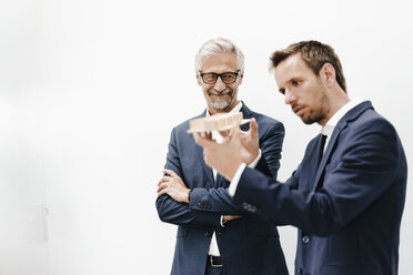 Two businessmen examining architectural model - KNSF02184