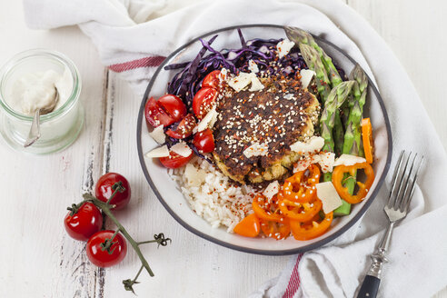 Vegetarian lunch bowl of rice, various vegetables and courgette feta fritter - SBDF03267