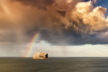 UK, Scotland, North Berwick, Firth of Forth, view of Bass Rock with rainbow and storm clouds - SMAF00776