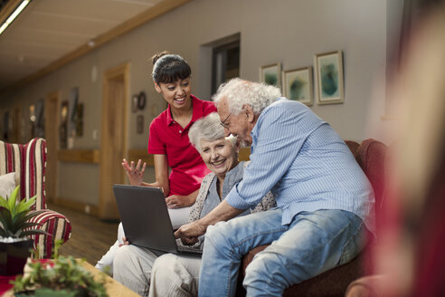 Seniors at retirement home looking at photo albums - ZEF14235