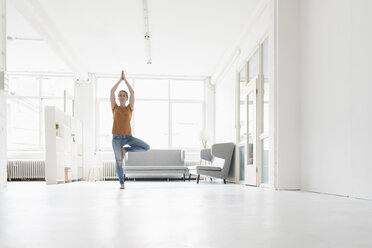 Frau übt Yoga in einem Loft - KNSF02234