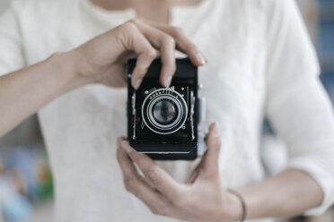 Woman's hands holding vintage camera - KNSF02235