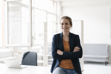 Portrait of smiling businesswoman in a loft - KNSF02236