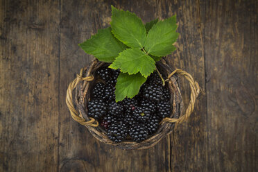 Wickerbasket of organic blackberries on wood - LVF06235