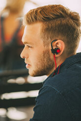 Young man wearing headset outdoors - CHAF01934