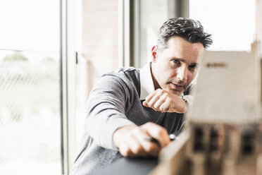 Architect working on architectural model - UUF11250