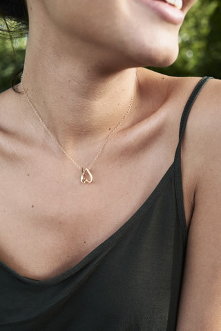 Cleavage of a young wiman with a golden necklace stock photo