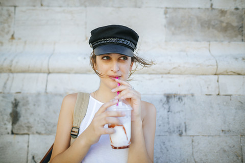 Portrait of young woman drinking a smoothie stock photo