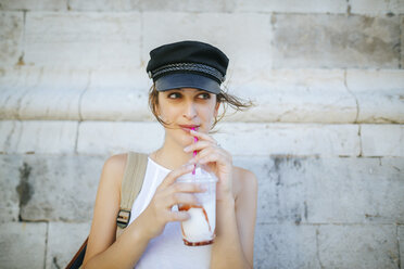 Portrait of young woman drinking a smoothie - KIJF01668