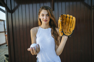 Portrait of young woman with baseball and baseball glove - KIJF01689