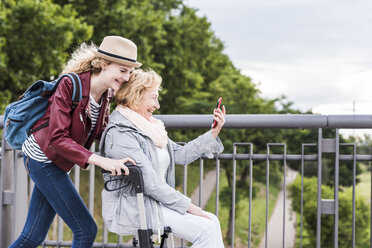 Grandmother and granddaughter having fun together - UUF11360