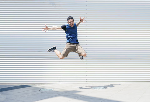 Young man jumping in the air stock photo