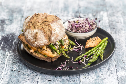 Lachsburger mit grünem Spargel und roter Kresse auf Teller - SARF03347