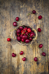 Wickerbasket of cherries on wood - LVF06256