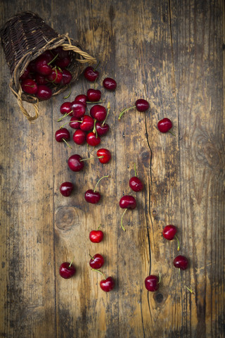 Wickerbasket of cherries on wood stock photo