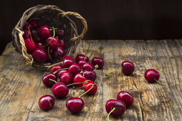 Wickerbasket of cherries on wood - LVF06258