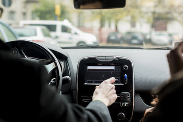 Close-up of businessman using navigation device in car - MAUF01171