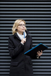 Blonde business woman with diary, portrait stock photo