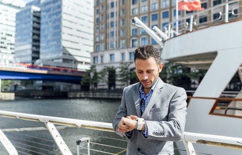 Businessman checking the time in the city stock photo