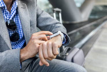 Close-up of businessman using his smartwatch in the city - MGOF03490