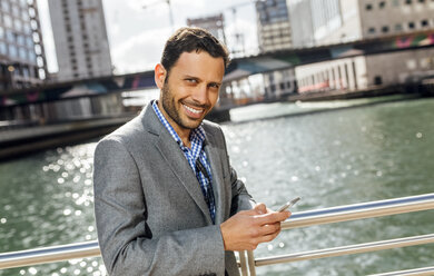 Portrait of a smiling businessman in the city - MGOF03524