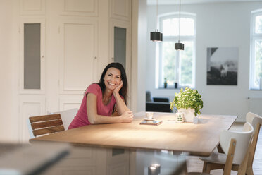 Portrait ofsmiling woman sitting at table at home - JOSF01285