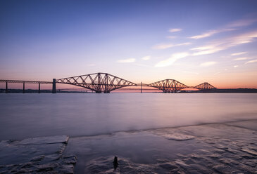 UK, Scotland, Fife, Edinburgh, Firth of Forth estuary, Forth Bridge, Forth Road Bridge and Queensferry Crossing in the background at sunset - SMAF00813