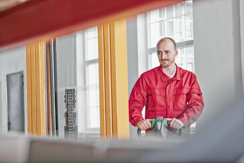 Confident man in factory using forklift stock photo