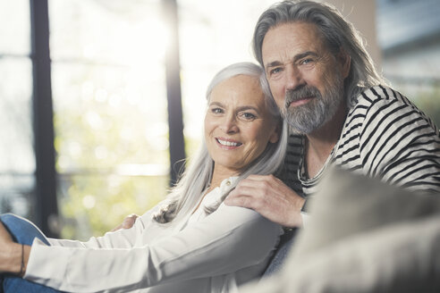 Happy senior couple sitting at home - SBOF00473