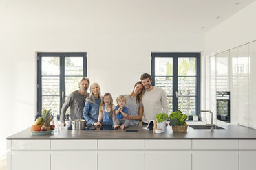 Happy family with grandparents and children standing in the kitchen - SBOF00509