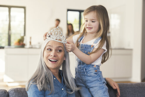 Granddaughter putting crown on grandmothes head - SBOF00539