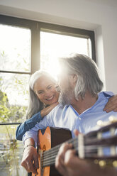 Senior playing guitar and singing loud for his wife - SBOF00551