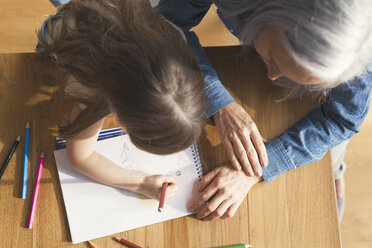 Grandmother and granddaughter making a drawing together - SBOF00572