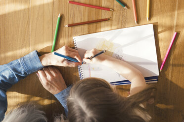 Grandmother and granddaughter making a drawing together - SBOF00573