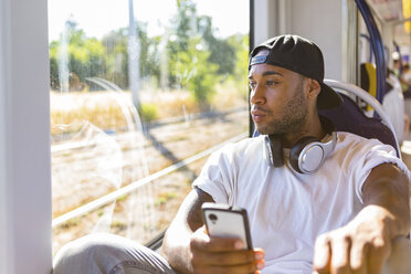 Young man in tramway looking out of the window - MGIF00067