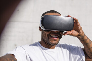 Man wearing Virtual Reality Glasses taking selfie - MGIF00072