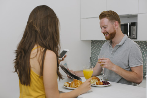 Couple having breakfast in the kitchen stock photo