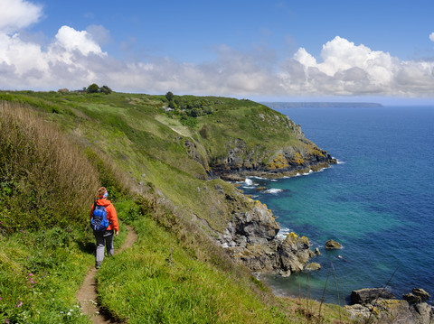 UK, England, Cornwall, The Lizard, woman hiking at the coast near Cadgwith stock photo