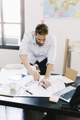 Architect working on construction plan - GIOF03035