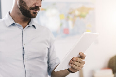 Businessman using tablet, partial view - GIOF03063