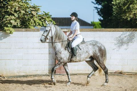 Young woman riding on horse stock photo