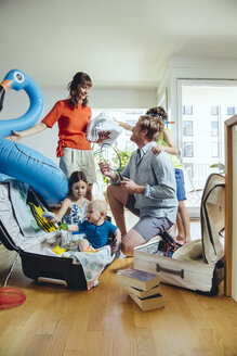 Happy family of five packing for holiday trip - MFF03776