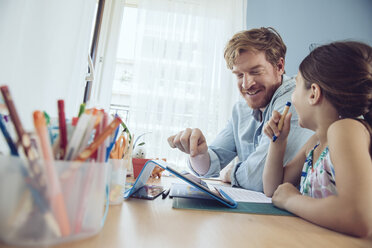 Father and daughter using tablet at home - MFF03787