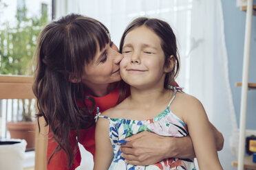 Mother kissing cheek of daughter - MFF03806