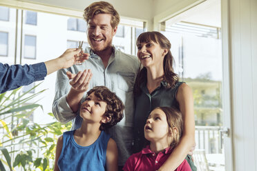 Family receiving key to their new home - MFF03808